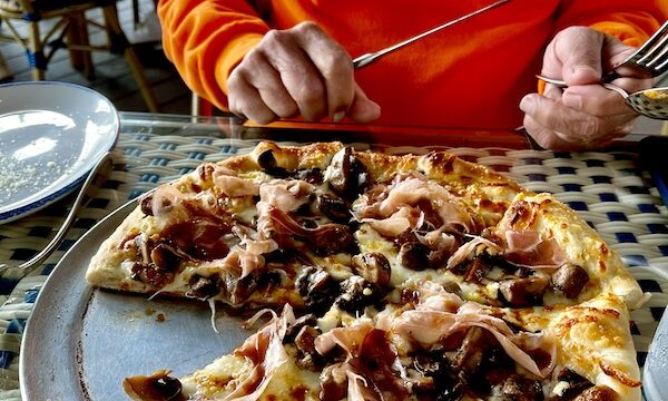 At George's Bistro and Bar Houston TX we shared the mushroom and prosciutto pizza served on the pan. Shown with my slice missing.