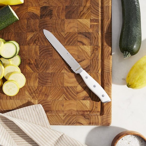My New Henckels Paring and Utility Knives showing the utility knife on a wood cutting board with sliced and whole veggies.
