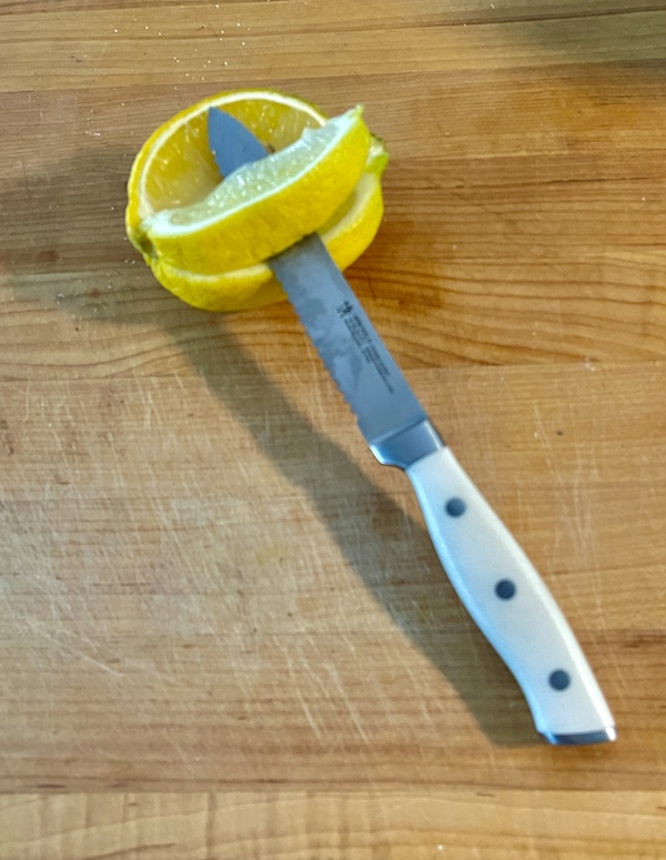 My New Henckels Paring and Utility Knives showing utility knife sliced through a lemon on a cutting board