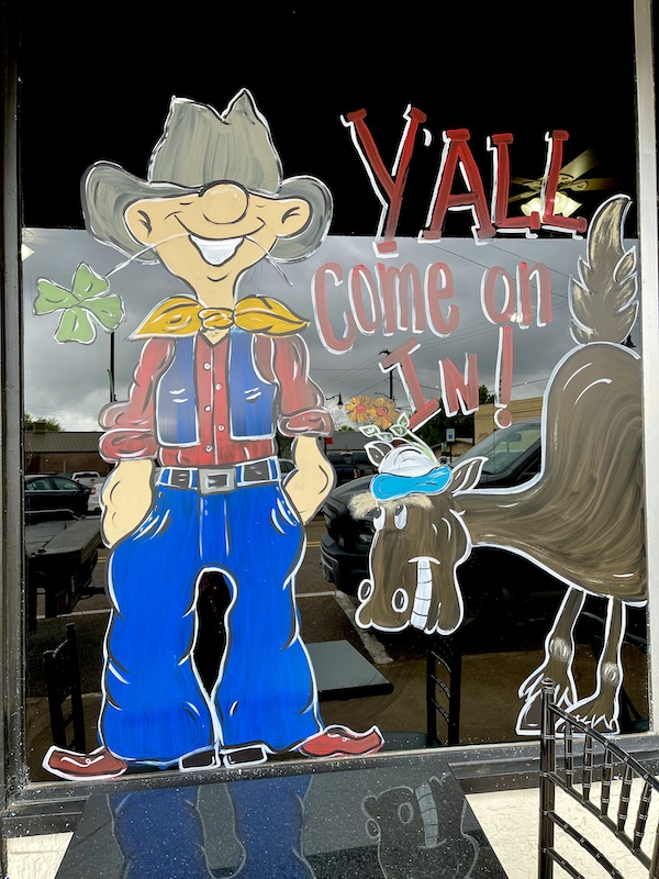 Restaurant window with painting of a cowboy