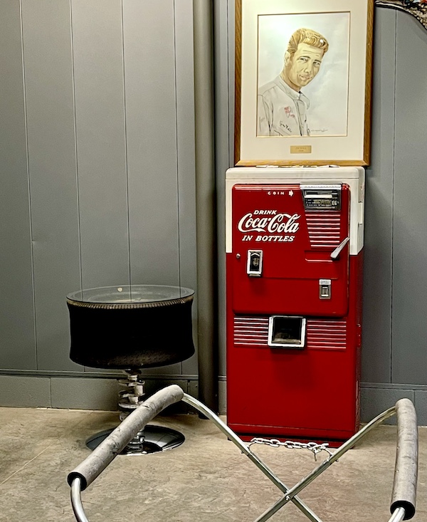 Portrait of Jim Hall, red Coke machine and a table made from a tire at the Chaparral Gallery Petroleum Museum