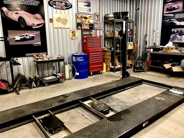 Mechanic garage with lift, pit and red tool chest at the Chaparral Gallery Petroleum Museum