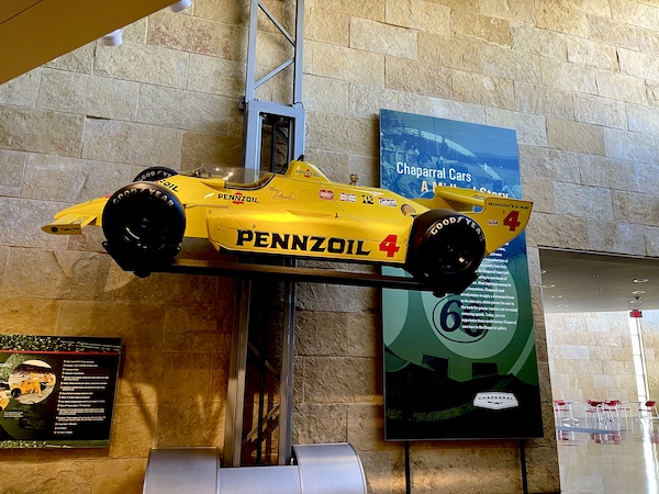 Bright yellow 2K Indy Car on a wall display at the Chaparral Gallery Petroleum Museum