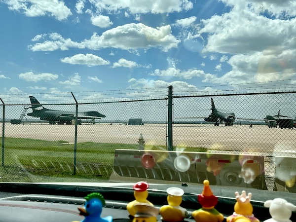 Colorful rubber duckies on the dash of our Jeep looking at the planes on the tarmac at Dyess Air Force Base Abilene TX