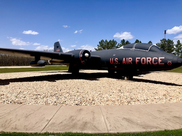 An old black jet with red writing on display at Dyess Air Force Base Abilene TX