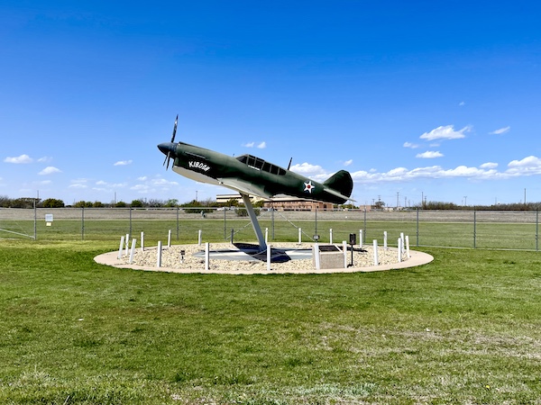 B-1 bomber sits just outside the gate on an oval cement pad and lawn at Dyess Air Force Base Abilene TX