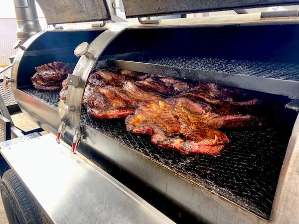 An open smoker displaying brisket being smoked at Get Around Brown BBQ Midland TX