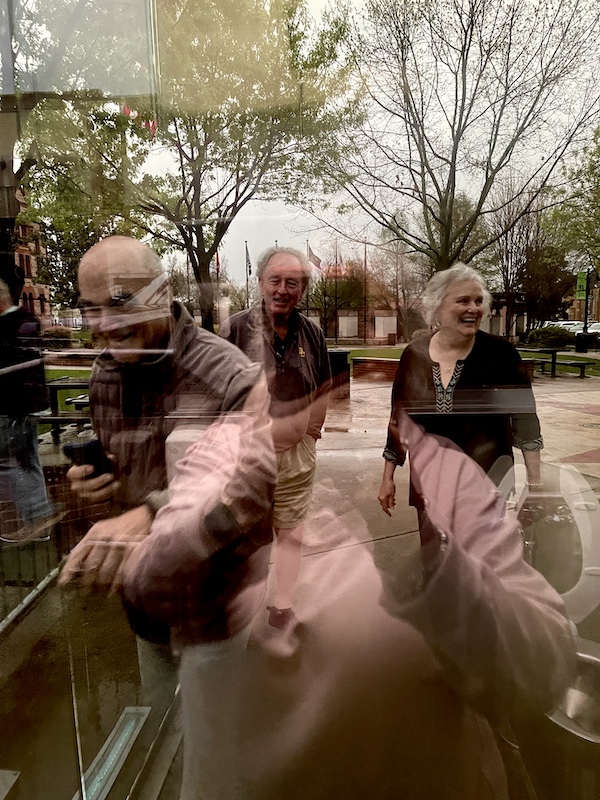 Reflection of me taking a photo of our friends and Steve who were outside of one of the Glass Bathrooms of Sulphur Springs TX