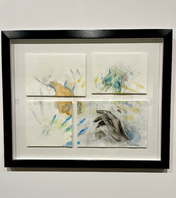 Four paintings framed together in black of hands on display at The Grace Museum Abilene TX