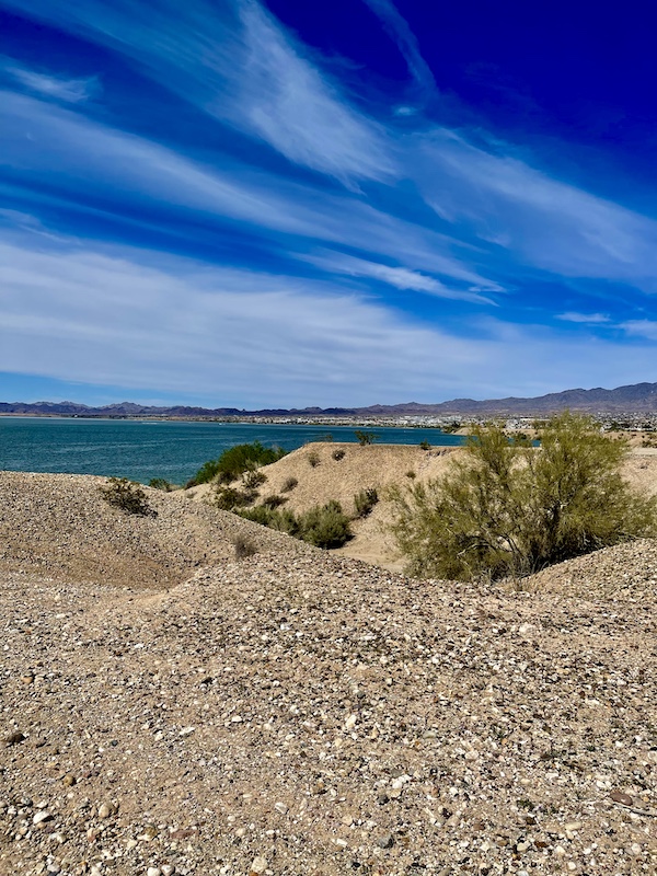 Desert sand, plants and a turquoise lake seen during our visit to Beautiful Lake Havasu Arizona