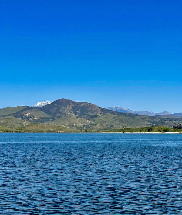 Snow-capped mountain and tree covered mountains surround Lake Skinner Temecula CA