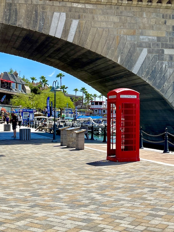 A red phone booth near an arch of London Bridge Lake Havasu AZ