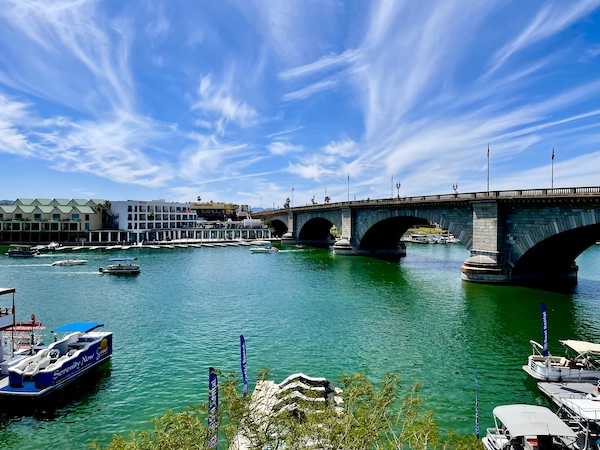 River with boats and hotels on opposite shore as you cross London Bridge Lake Havasu AZ