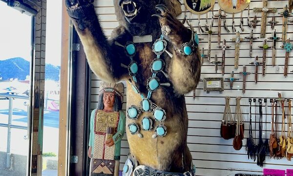 Enormous stuffed bear with silver and turquoise necklace and belt in a store in Quartzite Arizona