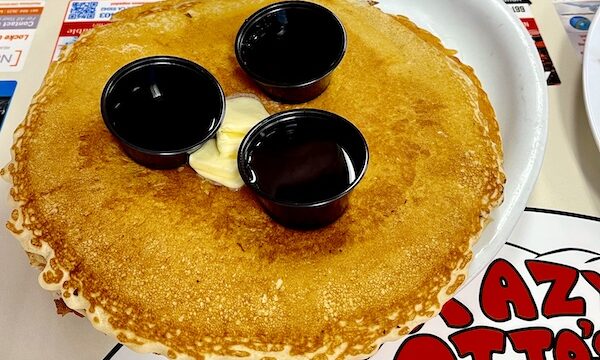 Pancake for Brunch at Crazy Otto's Diner with 3 black cups of syrup and butter/