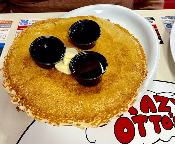 Pancake for Brunch at Crazy Otto's Diner with 3 black cups of syrup and butter/