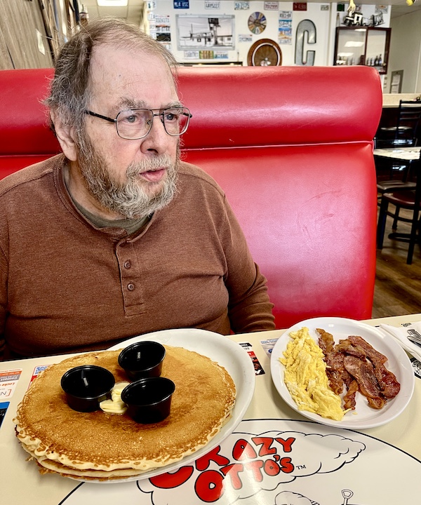 Man with beard sitting at table with his Brunch at Crazy Otto's Diner