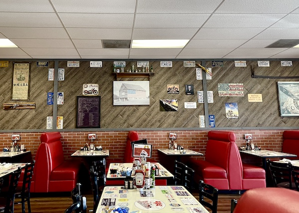 Red upholstered booths, tables and chairs at Crazy Otto's Diner