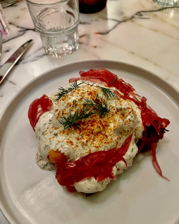 Plate topped with potato latke, smoked salmon, poached egg and pickled red onions at Moonlark's Dinette The Hoxton LA