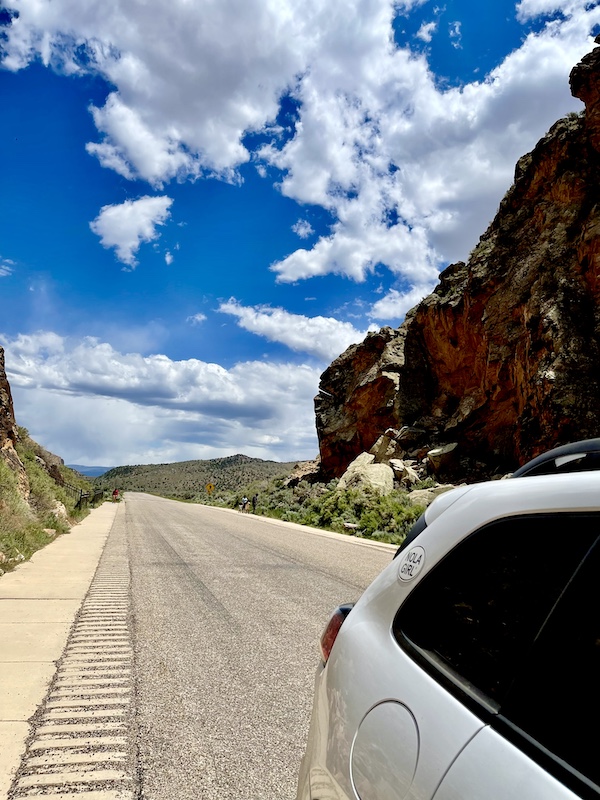 White jeep leaving the mountains and Petroglyphs of Parowan Gap Utah