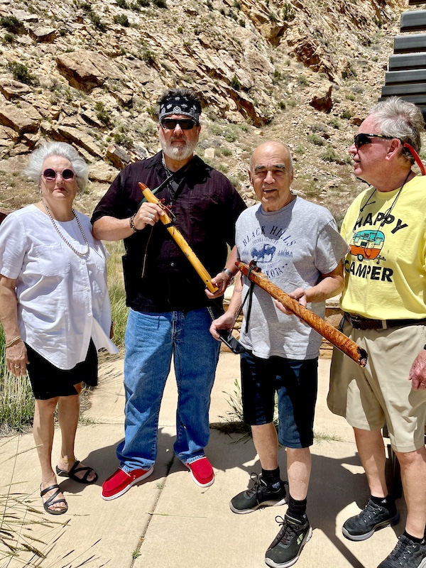 Sandee, Musician, Steve and Mack with wood instruments at Petroglyphs of Parowan Gap Utah