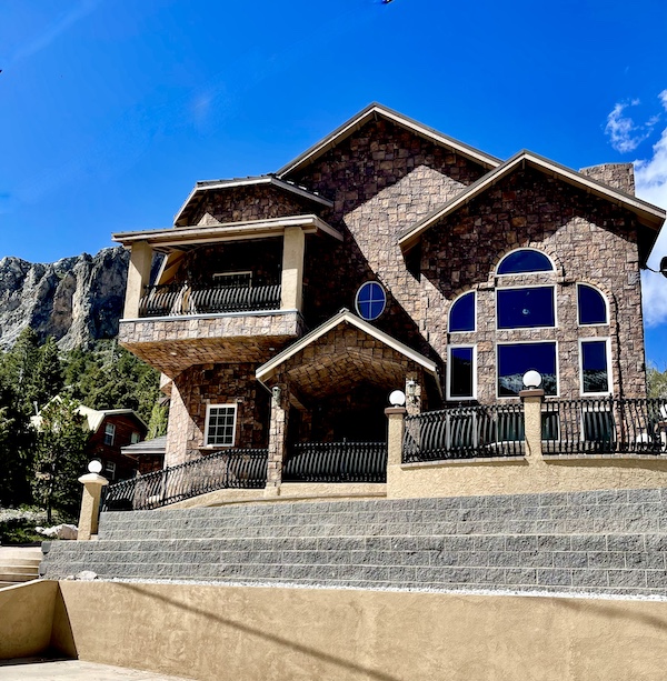 Large stone house with Scenic Mount Charleston Nevada in background