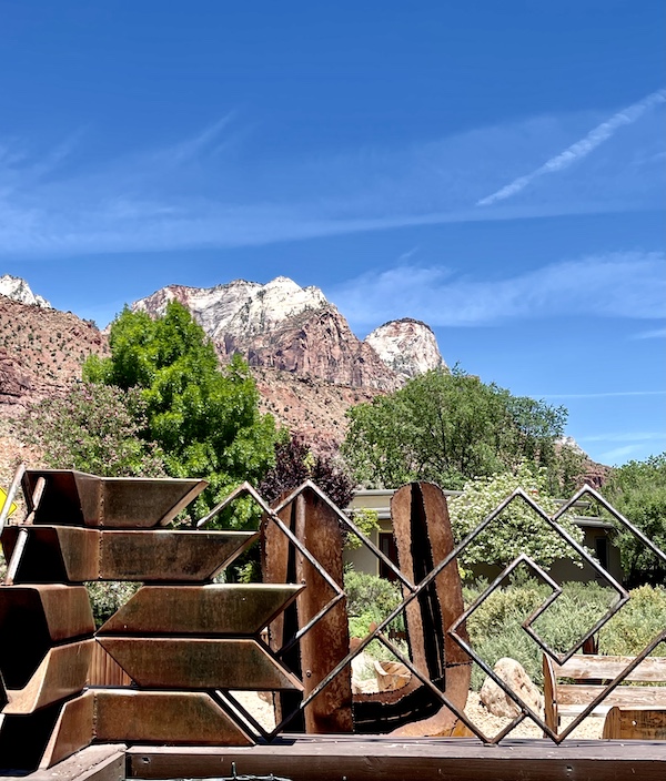 Metal sculpture, trees and mountains just outside of Zion National Park Utah