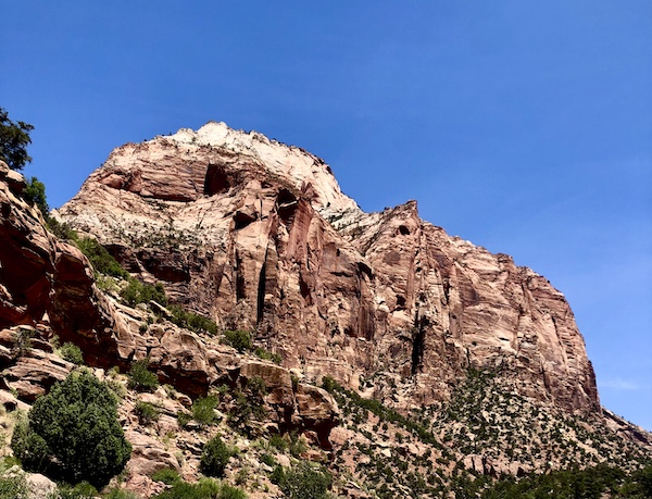 Mountain with holes creating what looks like a lion's face at Zion National Park Utah