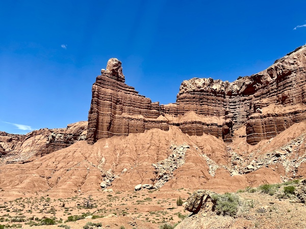 Red and white rock formations that resemble a fortress at Capitol Reef National Park