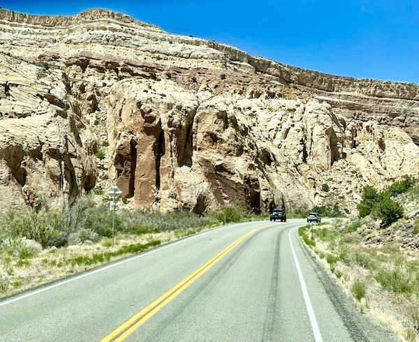 Capitol Reef National Park rock formation with lots of hiding holes and shadows along the highway.