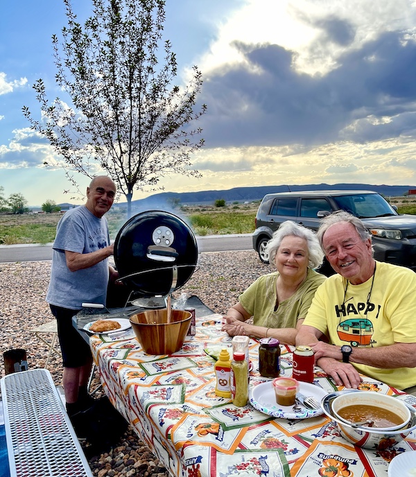 Two men and a woman at a picnic table in Delightful Parowań Utah