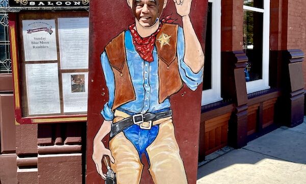 Steve behind a cutout of a cowboy with a big white cowboy had outside of Diamond Belle Saloon Durango