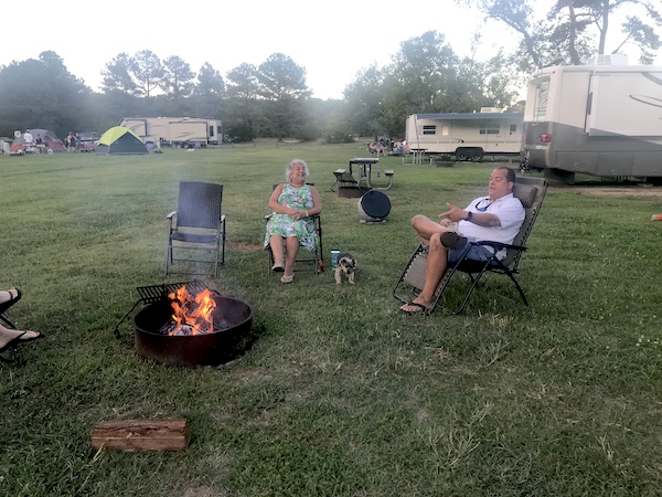 Campsite with roaring fire, Hershi on the grass and Brian and I sitting in chairs.