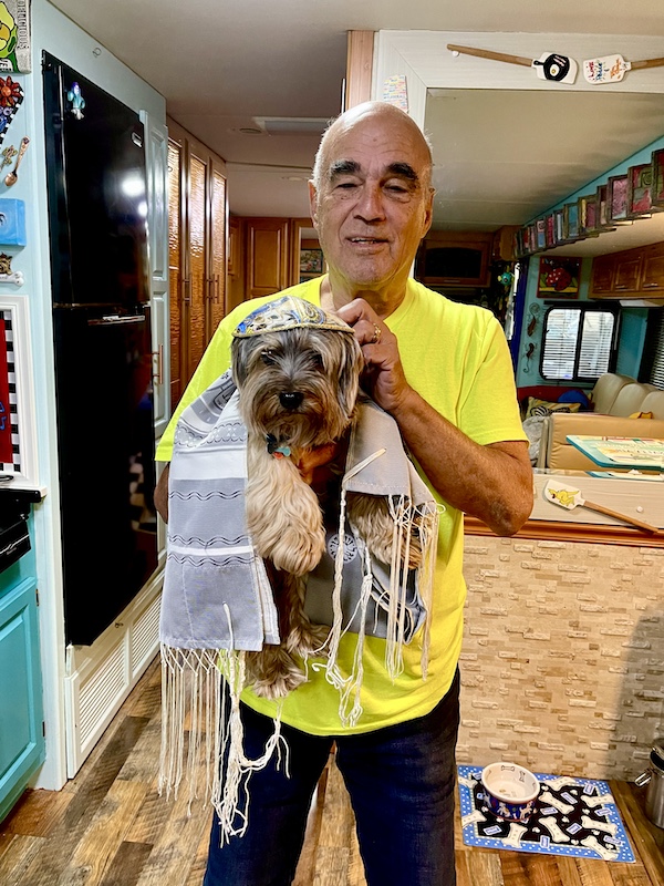 Steve holding Hershi who's wearing a yarmulke and tallit