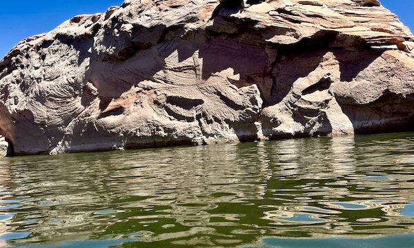 Rock formation that looks like a giant clamshell with smaller shells attached at Spectacular Lake Powell Utah