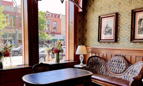 Strater Hotel Durango Colorado settee, lamps and tables with green print wallpaper.