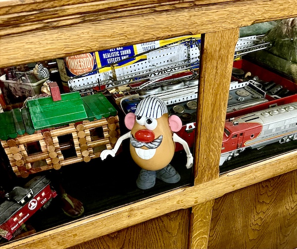 Mr. Potato Head and other antique toys on display at the