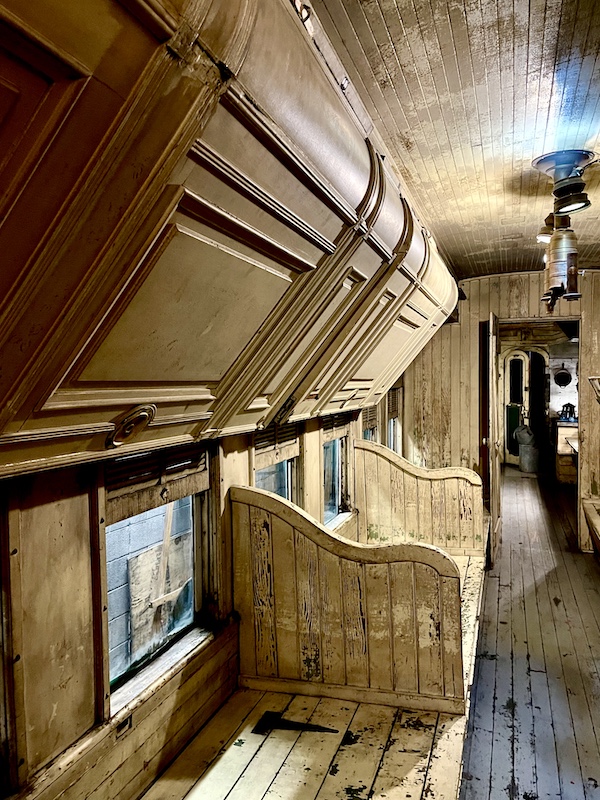 Light wood interior of an old sleeping car.