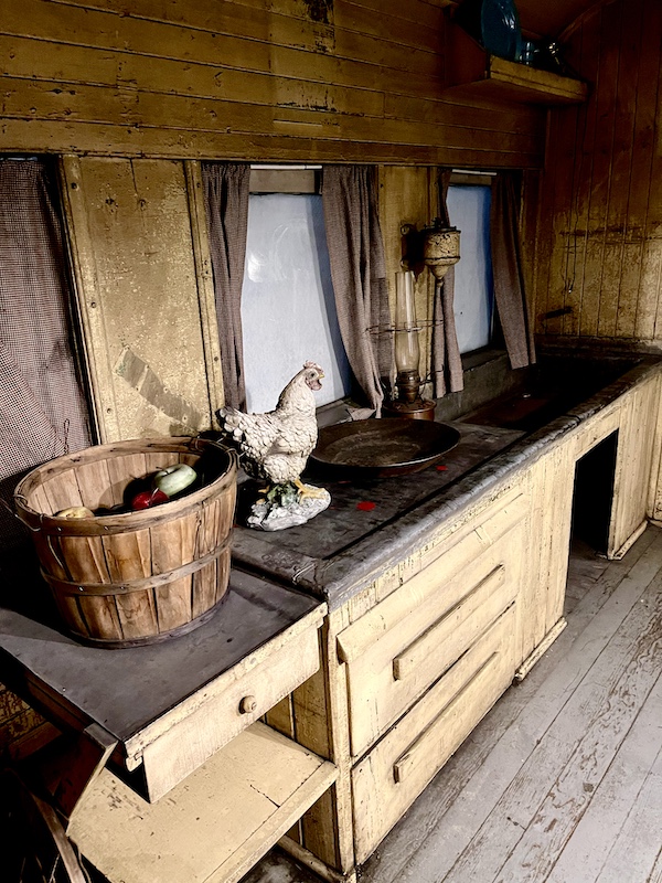 Light wood interior of a kitchen car on an old train.
