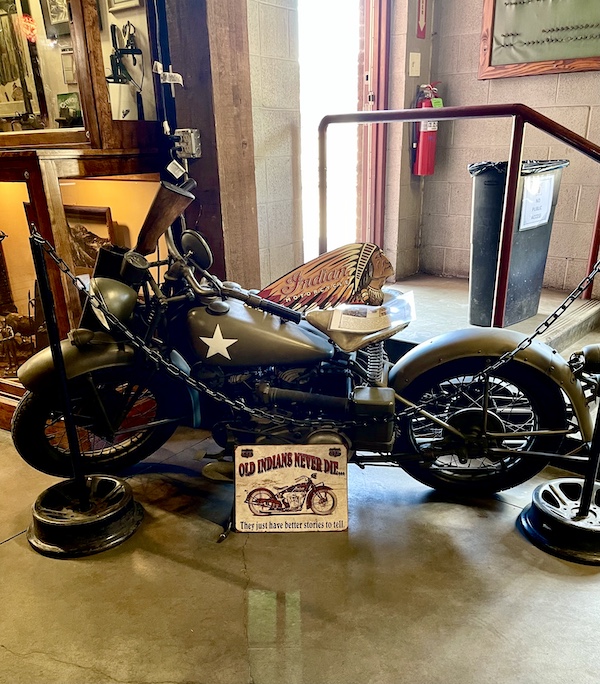 An army green motorcycle on display at the Durango and Silverton Narrow Gauge Railroad Museum