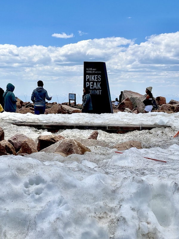 Lots of snow and tourists at the top of Pikes Peak in Colorado