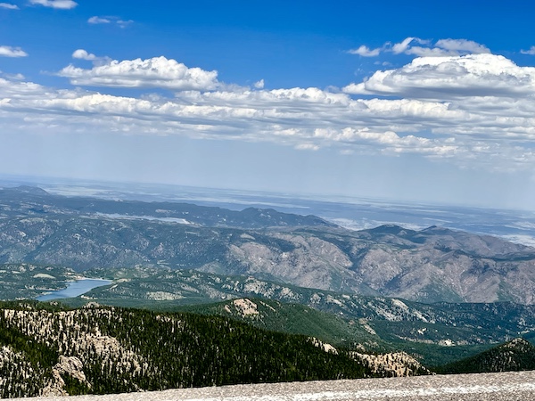 Mountains, trees and lake seen from above on our way up Pikes Peak in Colorado