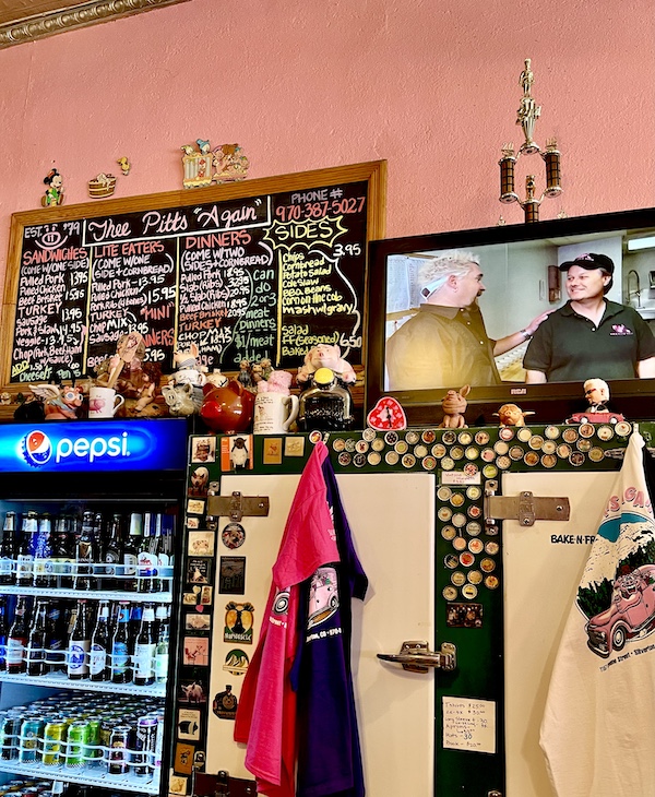 Thee Pitts Again BBQ chalkboard menu and memorabilia with pink walls