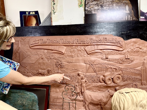 Clay sculpture wall with history of Nebraska Farm Bureau done by Artist Sondra Jonson Cambridge NE
