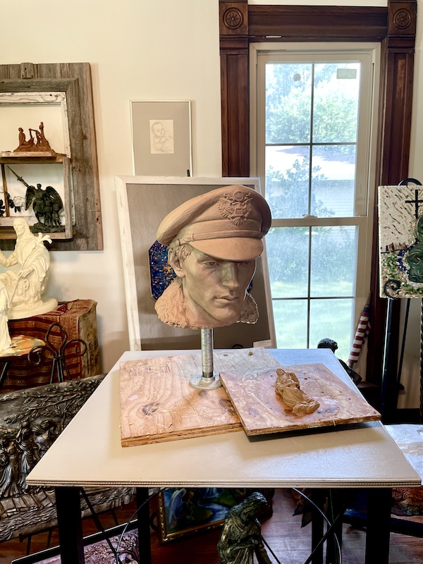 Clay sculpted head of an aviator with hat and support post through neck created by Artist Sondra Jonson Cambridge NE
