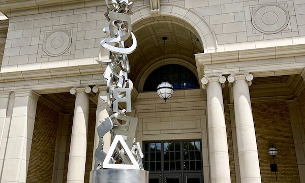 White building with columns and metal sculpture in front is an art museum at Notre Dame