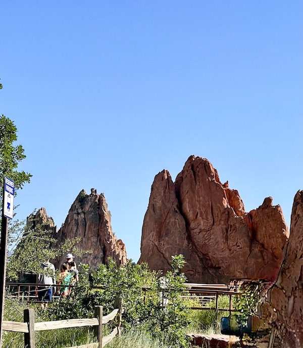 Red rocks popping out of the ground that look like pairs of hands praying