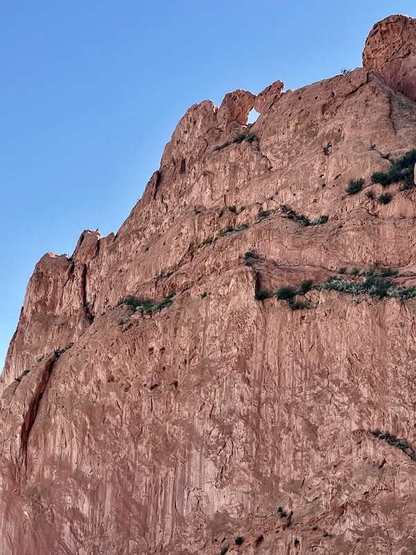 Huge rock formation with tiny hole at top that's open to the sky at Garden of the Gods