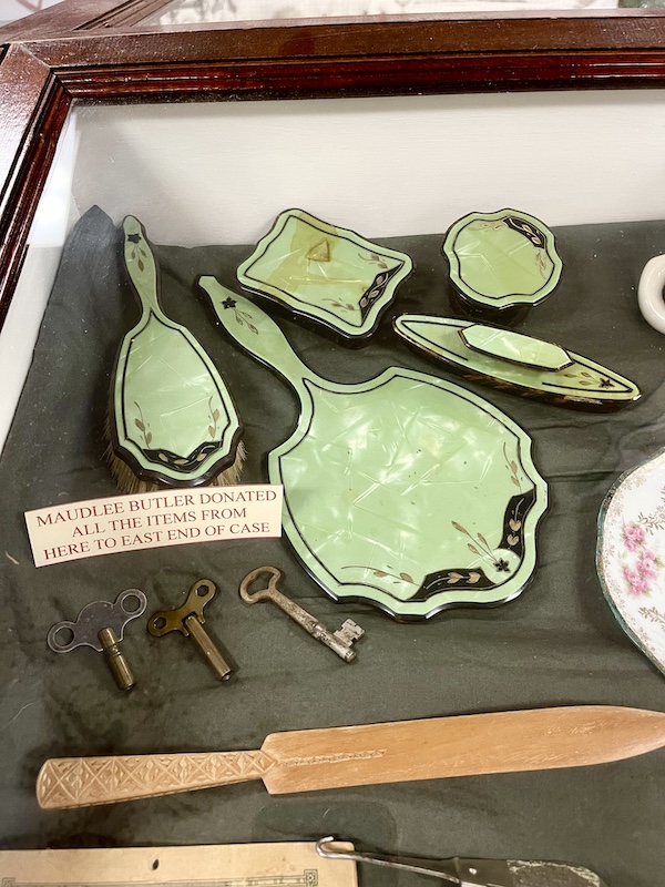 Mint green antique ladies grooming items on display at Nebraska's Cambridge Museum