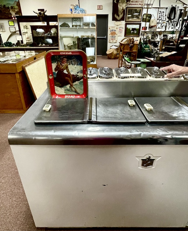 Old ice cream freezer with compartments for dispensing toppings for sundaes on display at Nebraska's Cambridge Museum